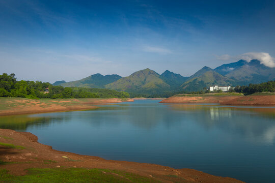 Scenic view of Banasura Sagar Dam reservoir with green hills and mountain reflection in Wayanad, Kerala, India