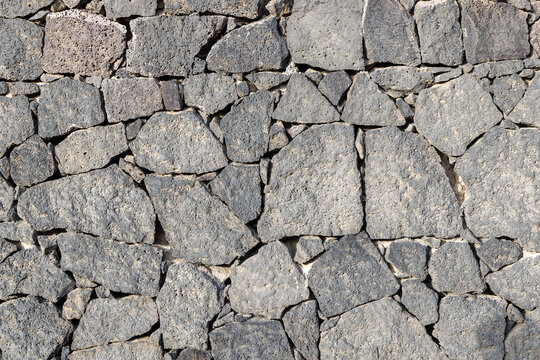 historic seamless volcano stone wall in grey as background