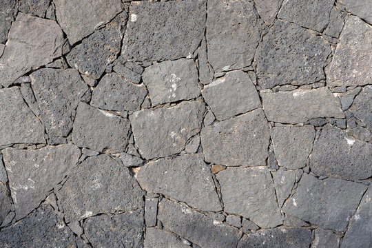 historic seamless volcano stone wall in grey as background