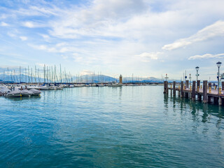 Fototapeta premium Beautiful sunset at Garda lake, Italy. Lighthouse in the port of Desenzano del Garda