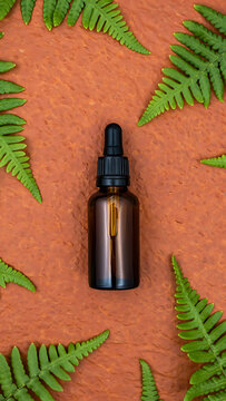 Amber Glass Dropper Bottle Mockup with Fern Leaves for Natural Beauty and Wellness Products