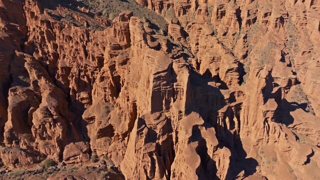 Awe-inspiring rock formations create a rugged landscape in Kyrgyzstan. Aerial drone view.