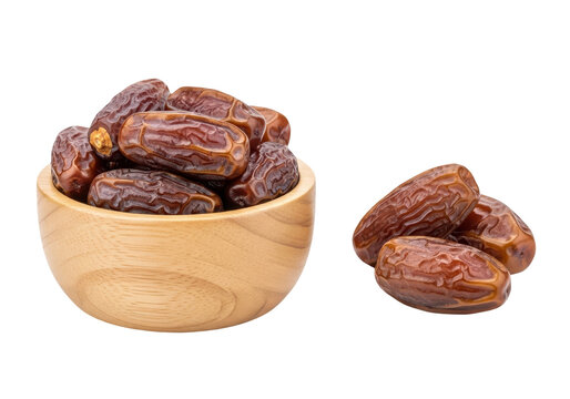 Dates in a wooden bowl and some loose on transparent background