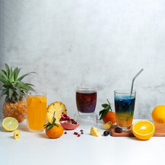 Fototapeta premium Fresh fruit drinks with citrus and berries on white background