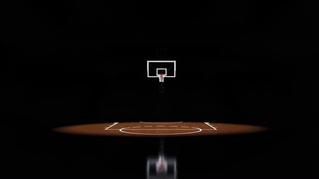 Slow dolly back revealing basketball hoop and hardwood court under spotlight in empty indoor arena with bleachers and overhead lights
