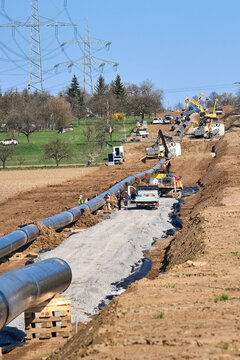 Large pipeline construction site in Ludwigsburg district, Baden-W&uuml;rttemberg, Germany. Workers and machinery install underground pipes for future gas and hydrogen energy supply across agricultural land