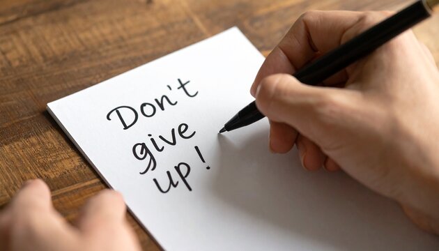 Handwritten note saying "Don't give up!", symbolizing motivation and resilience.