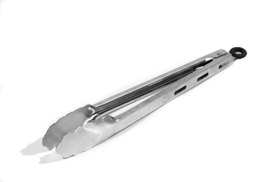 quality assortment of essential kitchen utensils including spatula, whisk, ladle, knives, neatly on a clean white surface, highlighting modern cooking tools and culinary preparation