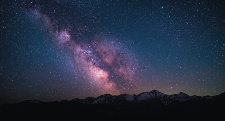 Fototapeta premium Galaxy and colorful starry sky with pink light over mountain range