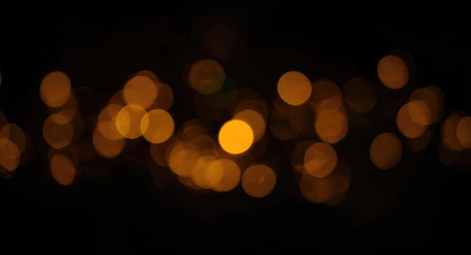 Dark abstract background illuminated by diffused yellow circle lights including copy space