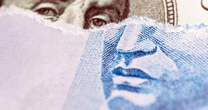 Detail video of a Brazilian one-hundred-real note, next to one-hundred American dollar notes. Economic crisis and rise in the American currency, rise or fall of the dollar in reference to the Brazilia
