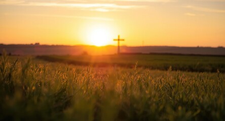 Naklejka premium Peaceful rural meadow at sunset with bokeh reflections and a solitary cross