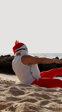 Santa Claus on a summer beach vacation, relaxing in flippers