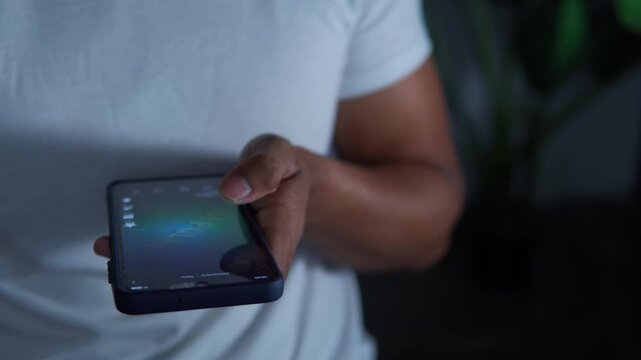Addict man using a mobile at night