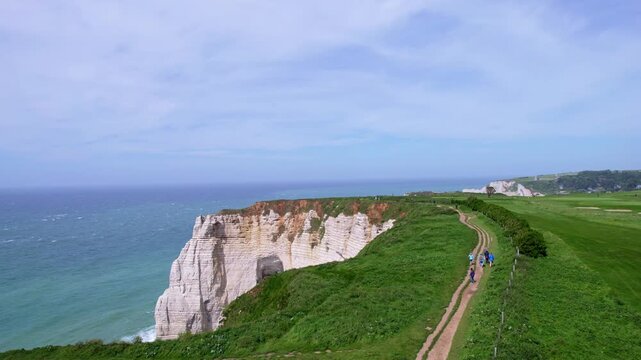 Aerial view trail along the cliffs of Etretat, Normandy, with the sea in the background