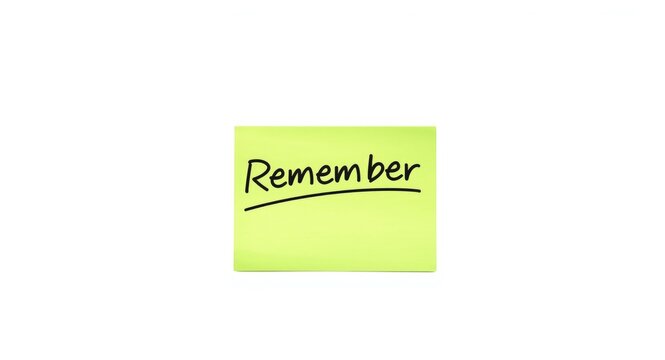Green reminder sticky note with remember text on minimal white background