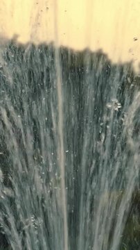 Close-up of a fountain. A small fountain in an artificial lake in a park in a large city.