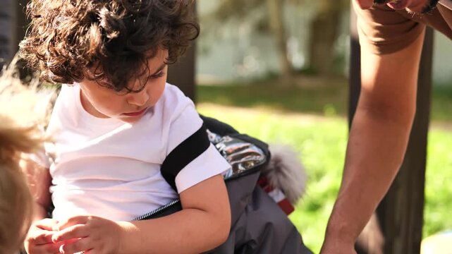 Armenian child getting help from parent zipping new winter snowsuit outdoors