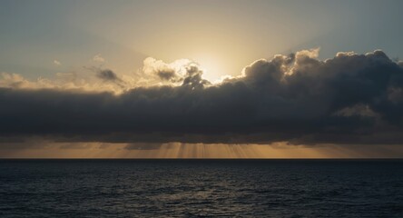 Fototapeta premium Heavy clouds obscuring sun over ocean