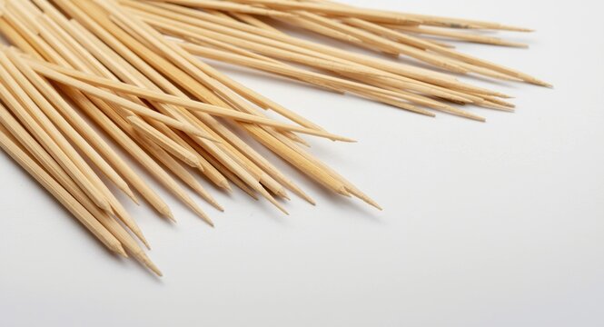 Scattered Mikado sticks over a neutral white background