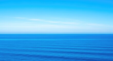 Fototapeta premium Wide open shot of a vibrant blue sky meeting the deep blue ocean water at a perfect, uninterrupted horizontal line, water, azure, tranquil