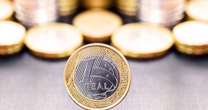video of one real coins in close-up, neutral black background with space for text, copyspace, economy or newspaper vignette or savings concept