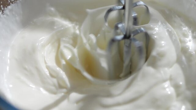 Beat the cream for the cake with a mixer. Confectionery mixture for greasing the cakes.