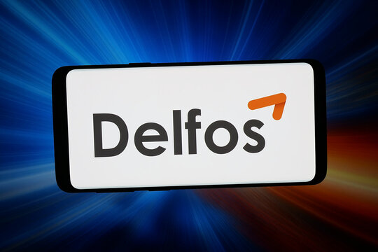 Stuttgart, Germany - 03-19-2026: In this photo illustration, the logo of Spanish renewables compaony Delfos Energy SL is displayed on a smartphone in front of abstract background on computer screen.