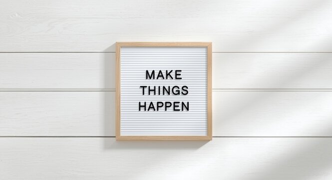 Make things happen phrase on minimalist board over whitewashed wooden surface with copy space included