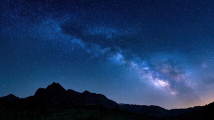 Obraz premium Starry Roadmap: Milky Way Arc and Cassiopeia in a Deep Blue Night Sky
