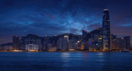 Naklejka premium Illuminated coastal city skyline with high-rise buildings at twilight for animation