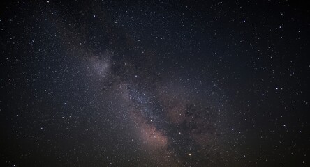 Fototapeta premium Energetic fireworks display under a wide star studded sky including Milky Way