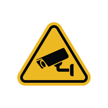 A yellow triangle warning sign indicates a surveillance camera is present.