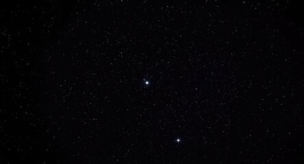 Fototapeta premium glistening twin stars illuminating a deep black night sky