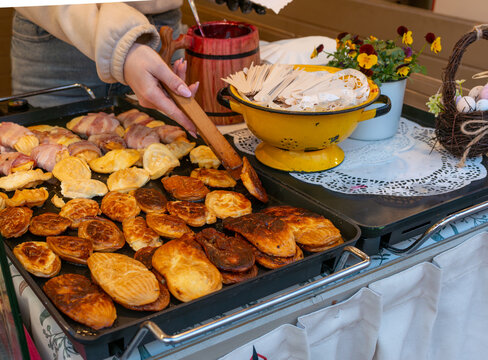 Fresh baked oscypek cheese pastries and bacon wrapped snacks served on tray with wooden skewers and sauce. Authentic polish street food concept for traditional cuisine, market, snack, grilling and loc