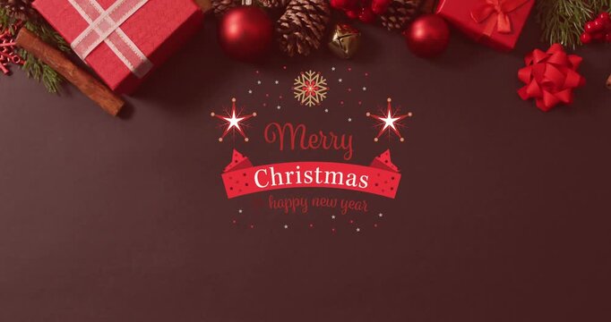 Animation of christmas greetings text over christmas presents and decorations
