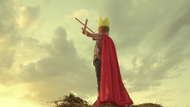 happy family. little boy playing with ball sunset wearing golden paper crown. chidhood dream. kid child plays park against sky. superhero child red cape. superhero child play concept.outdoors. chid.