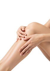 Fototapeta premium close-up of a young woman's slender leg and bent knee, a delicate hand gently touching the shin, showcasing smooth skin texture against a flawless white studio backdrop, concept of luxurious