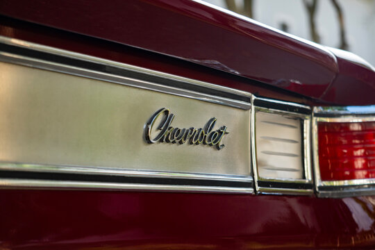 Dark red Chevrolet Opala rear script badge macro detail, Classic vintage coupe model emblem closeup