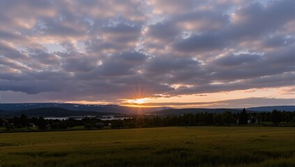 Fototapeta premium Timelapse of mooving clouds over field before sunset in Southern Norway 