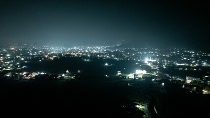 Aerial Night Cityscape with Glowing Lights and Dark Skyline Panorama © Kamitana
