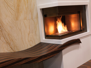 Naklejka premium Modern Gas Fireplace, artistic contemporary interior design with flowy curves.