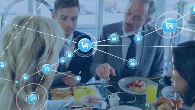 Animation of network of digital icons over diverse businesspeople discussing while having lunch