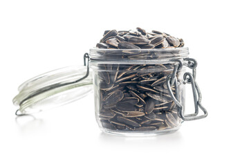 Fototapeta premium Glass Jar Filled With Sunflower Seeds On White Background. Closeup Healthy Snack