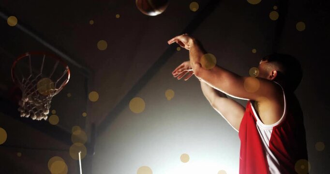 Animation of caucasian basketball player throwing ball and spots of light on black background
