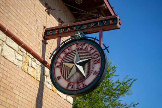 Cedar Drive Allen Station Park Sign With Star Logo On Brick Building in Allen, Texas