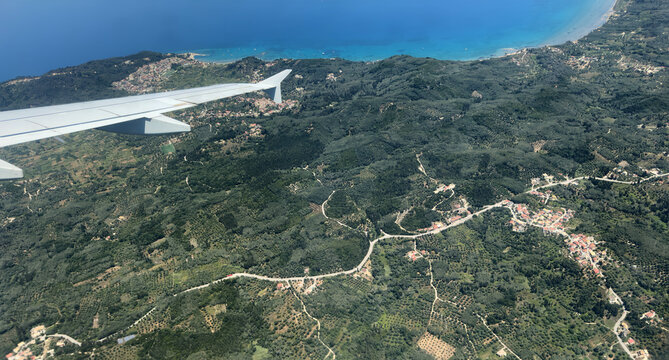 Aerial view of western Corfu coastline with Paleokastritsa bays and Glyfada beach under summer sun. Greece