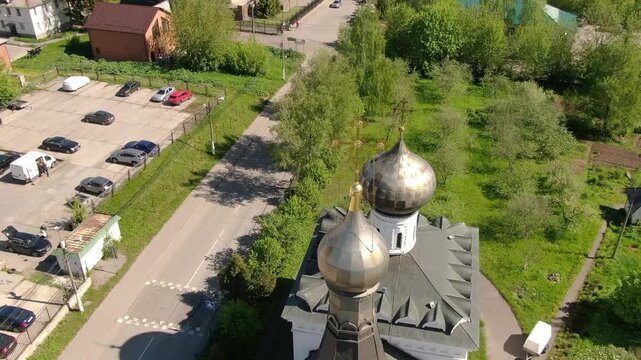 Drone lowering toward church dome in Klin