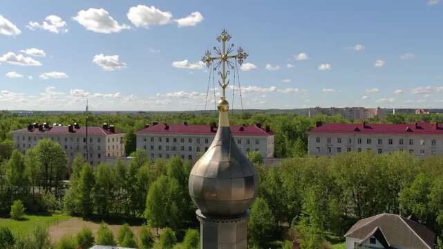 Drone orbiting near church cross
