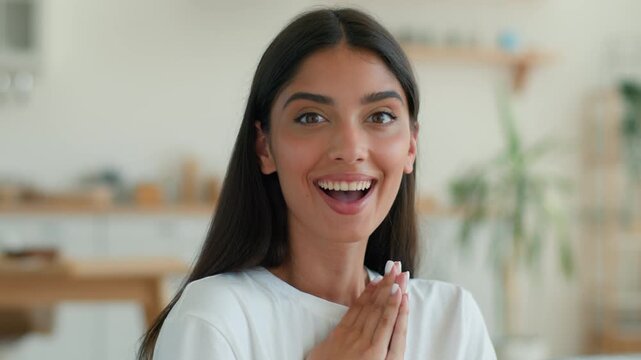 Surprised amazed Indian woman at home looking at camera wow reaction open mouth happy excited good news success achievement Arabian girl Latina female win celebration positive shocked face indoors